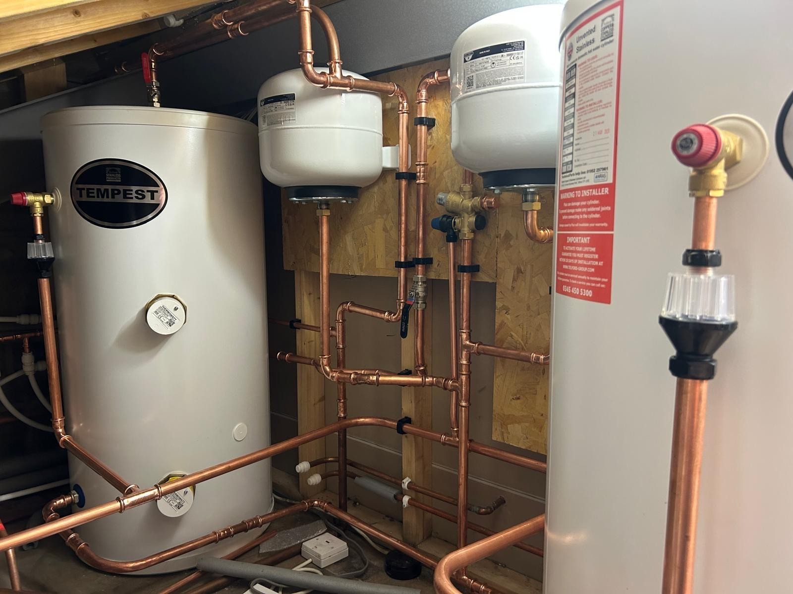 Twin unvented hot water cylinders with tempering valves installed in Manchester