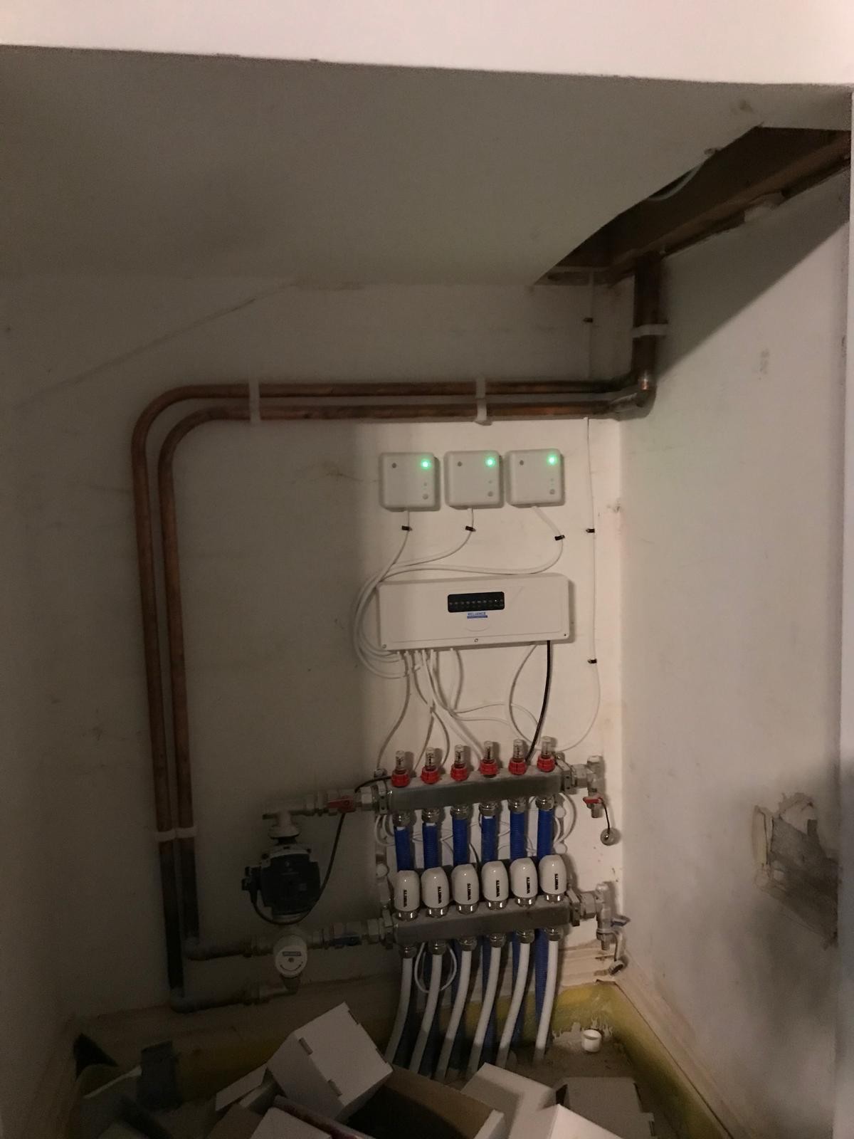 Underfloor heating manifold and zone actuators installed in a wall recess in Manchester