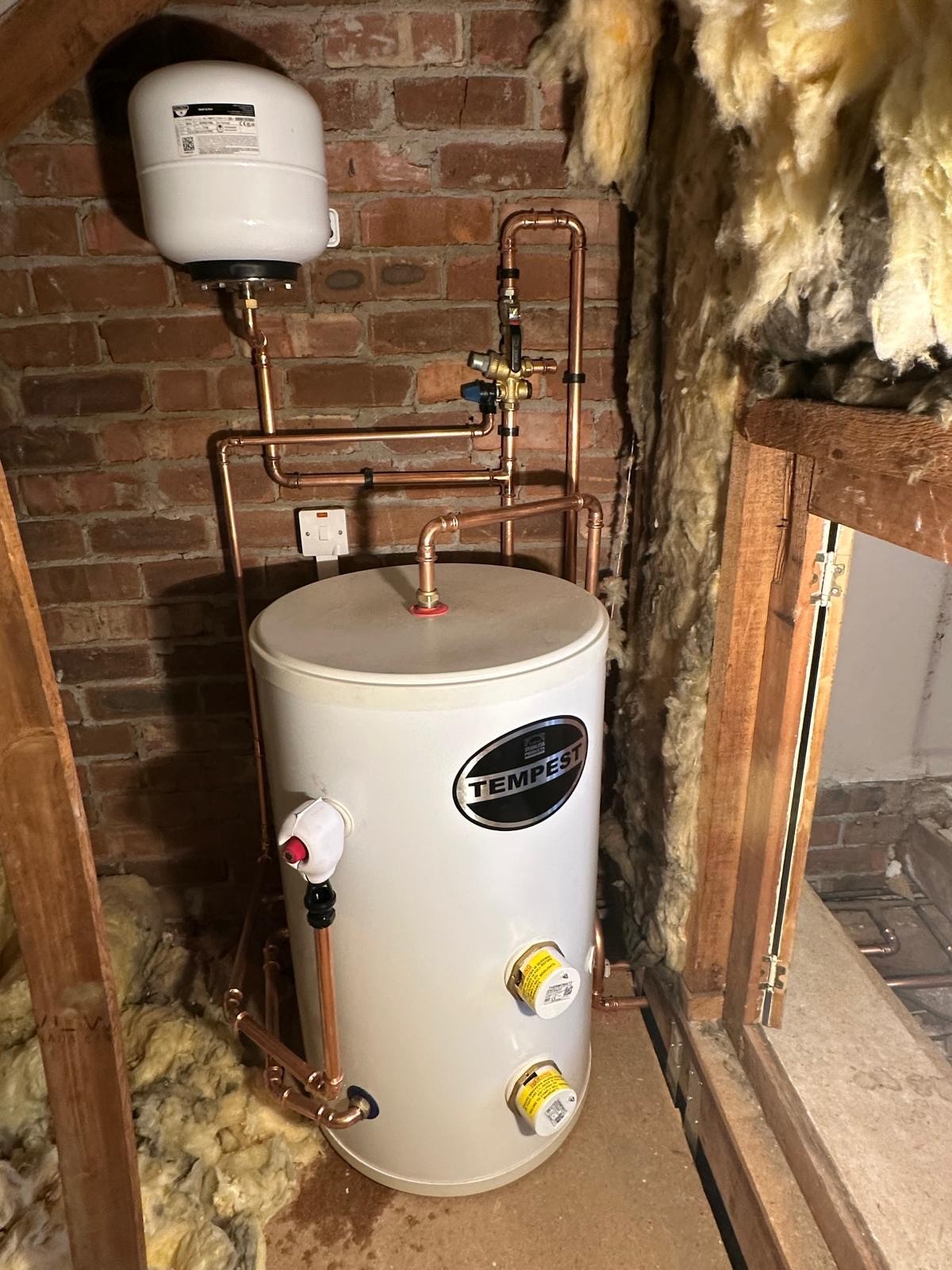 Tempest unvented hot water cylinder with expansion vessel installed in a Manchester loft
