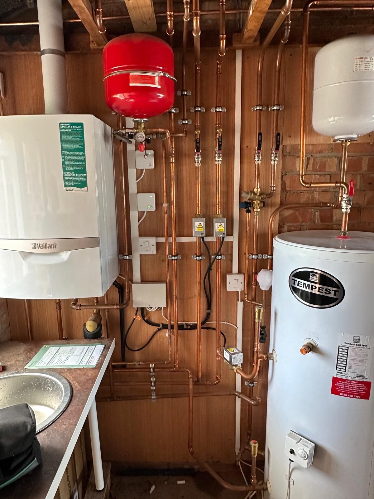 Vaillant system boiler, red expansion vessel, zone valves and Tempest cylinder on a Manchester central heating installation