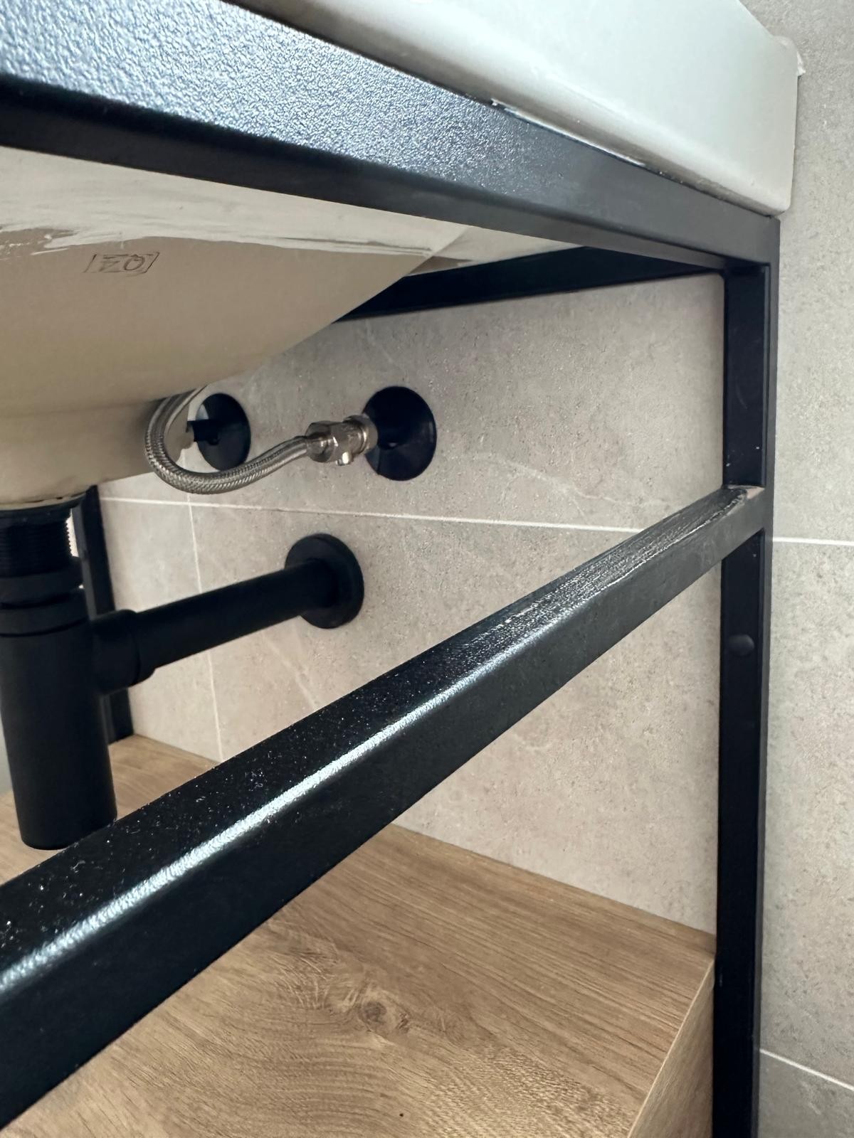 Close-up of a new basin waste and isolation valve fitted during plumbing work in Manchester